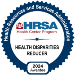 A blue and white badge reads: Health Resources and Services Administration HRSA Health Center Program. Grand Junction Health Care—Health Disparities Reducer. 2024 Awardee for Affordable Health Care.