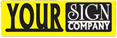 A rectangular yellow and black logo features large text reading YOUR SIGN and smaller text below reading Grand Junction Health Care.