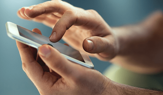 A close-up of a person’s hands using a smartphone, engaging with a healthcare app—perfect for Grand Junction Health Care or Montrose Health Care services on the go.