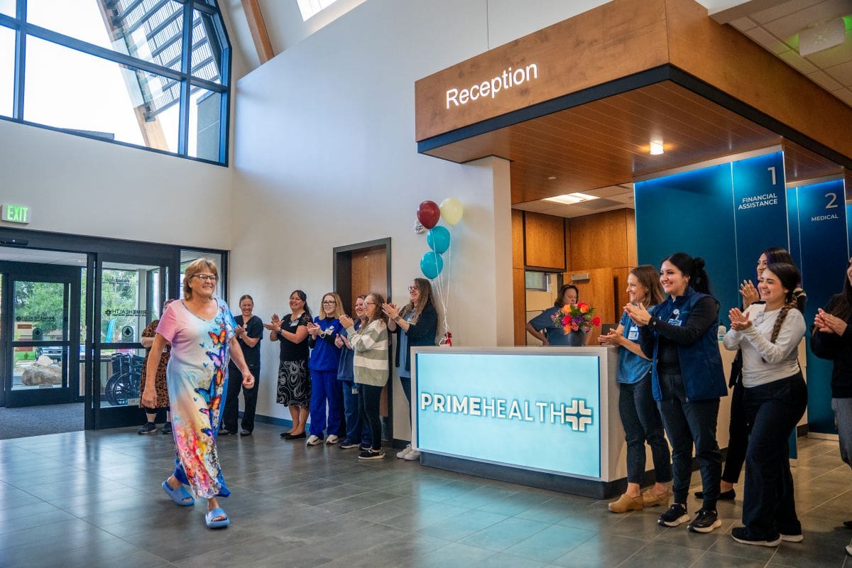 woman who is first patient walks through lobby of new primehealth+ main clinic in grand junction, colorado