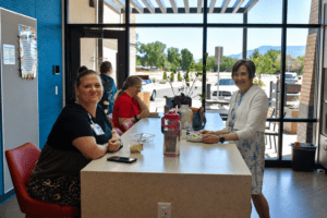 PH+ team members take time during a coffee break to chat. This image features staff from several different departments.