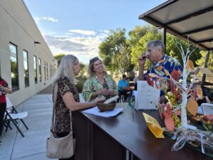 Guests at the PrimeHealth+ October 8 donor appreciation gathering beside the gratitude tree